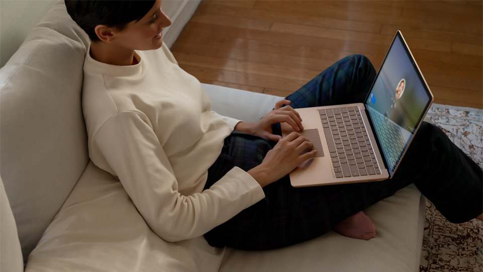 A person logs onto a Surface Laptop 3.
