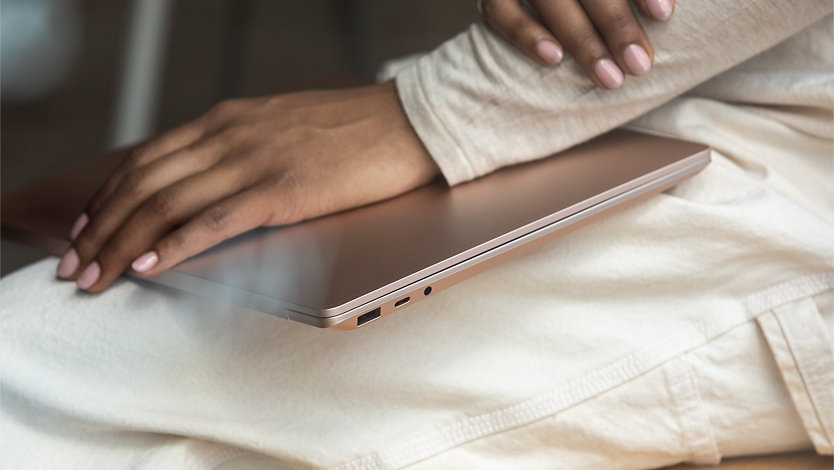 A person holds Surface Laptop 3 on their lap