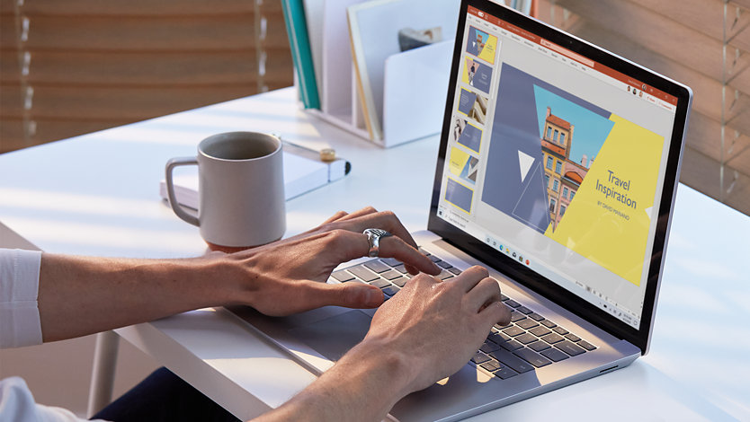A person uses Microsoft PowerPoint on Surface Laptop 3.