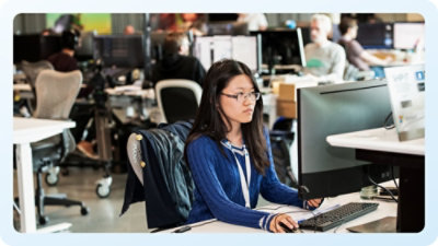 A person looking into computer screen.