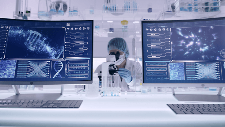 一个人在桌子前用显微镜观察，屏幕上显示着 DNA 等