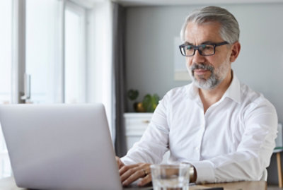 An old men working on laptop