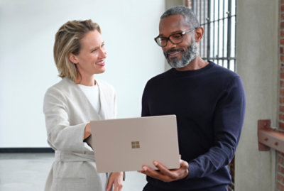 Two people discuss something about work in laptop