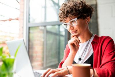 A person sitting at a table with a computer