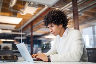 A person sitting at a desk using a computer