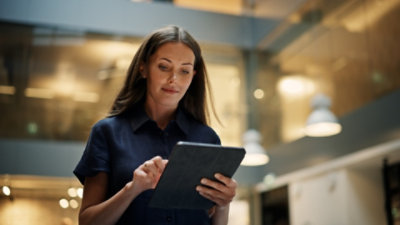 A woman is looking at a tab screen.