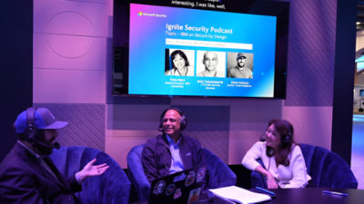 A woman and two men sitting in chairs.