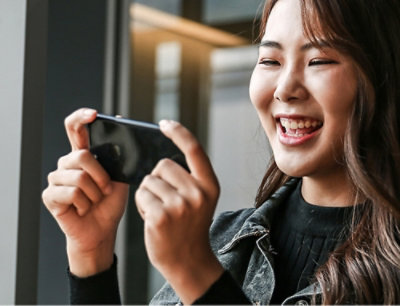 A woman looking down at her phone.