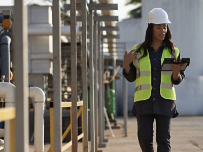 A person wearing a safety vest and a hard hat