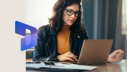 A woman sitting at a desk and working with her laptop.
