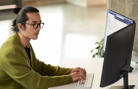 A man in his work on a laptop.