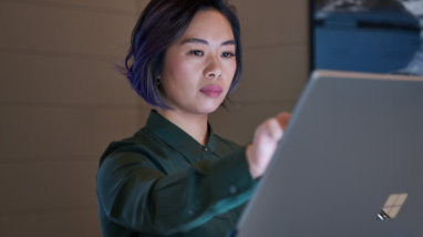A person reaching out to use a tablet device.