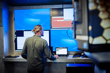 A man standing in front of a computer.