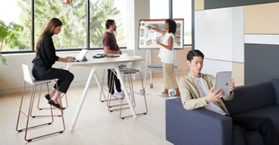 People working in an office, alone, and in pairs