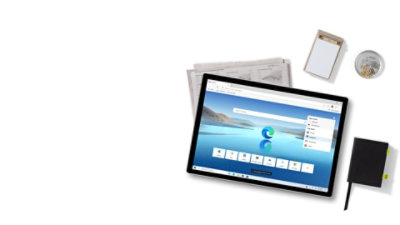 A group of office supplies, a newspaper and a tablet device displaying a Microsoft Edge window.