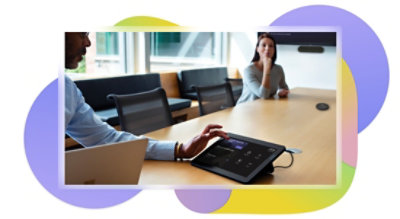 Two people in a meeting room setting up a Teams video call on a tabletop device.