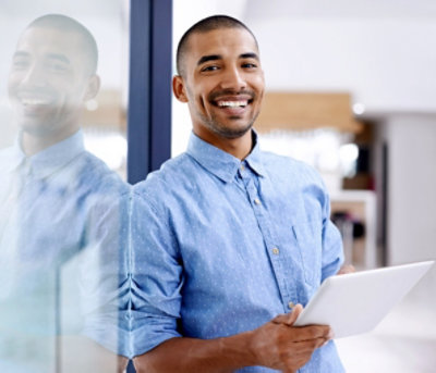 A person holding a tablet and smiling.
