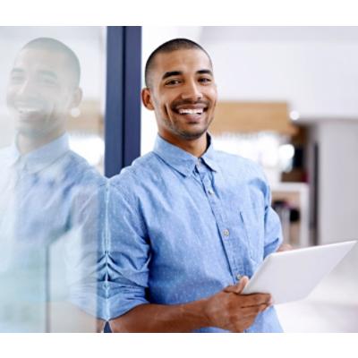 A person holding a tablet and smiling.