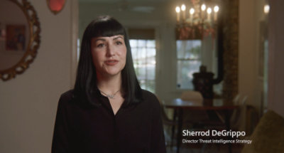 A close-up of a woman with black hair and bangs wearing a necklace, with visible text reading Sherrod DeGrippo Director Threat Intelligence Strategy.