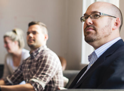 A person in a suit and glasses