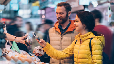Man and woman using smartphone payment app