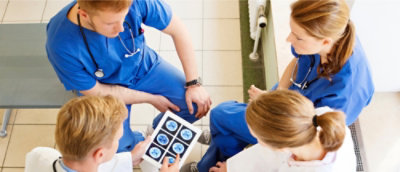 A group of doctors looking at x-ray images.
