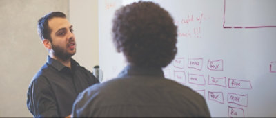 A person looking at a whiteboard.