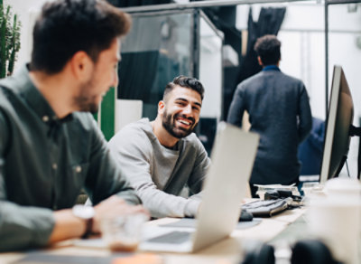 two people working with laptop in smiling face