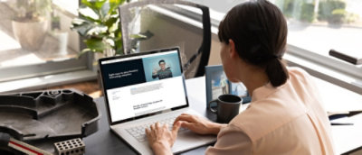 A woman typing on a laptop.