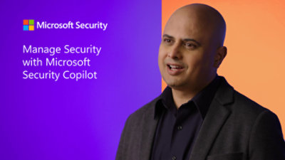 A bald man in a suit standing in front of a purple sign that reads Manage Security with Microsoft Security Copilot.