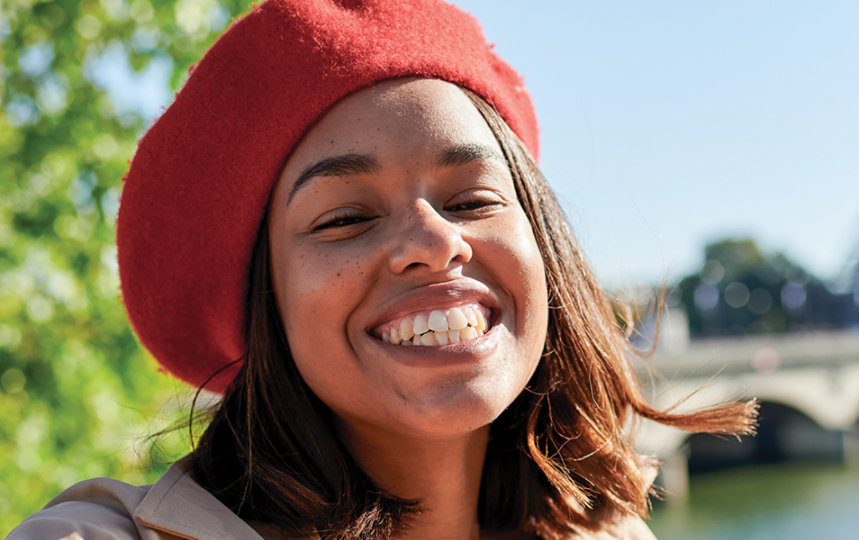 A woman takes a selfie in front of the Eiffel Tower in Paris.