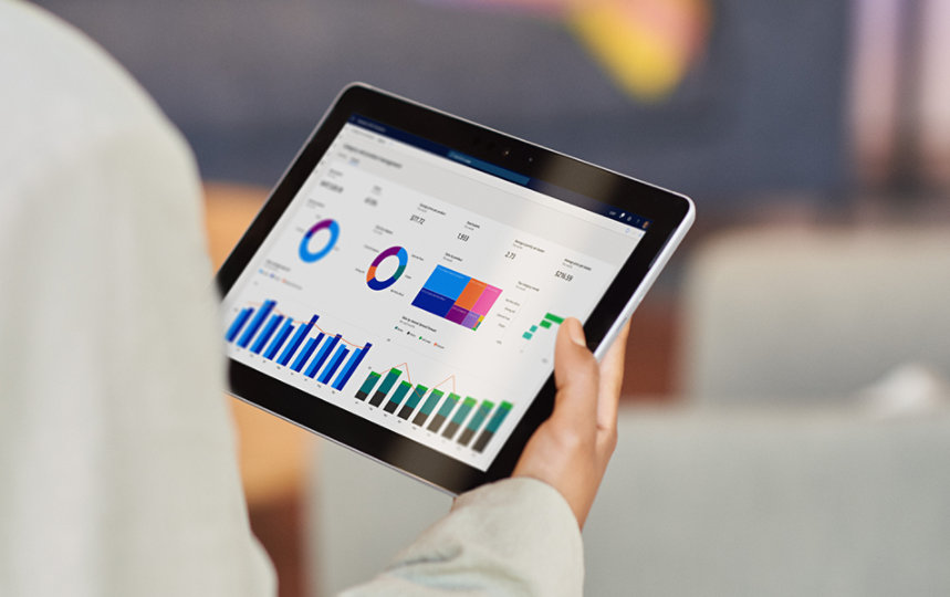 business woman dressed in white jacket looking on her tablet