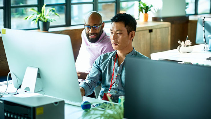 Two colleagues collaborating at a desk.