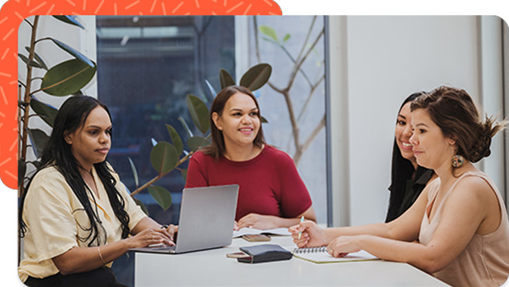 Four woman working together in an office.