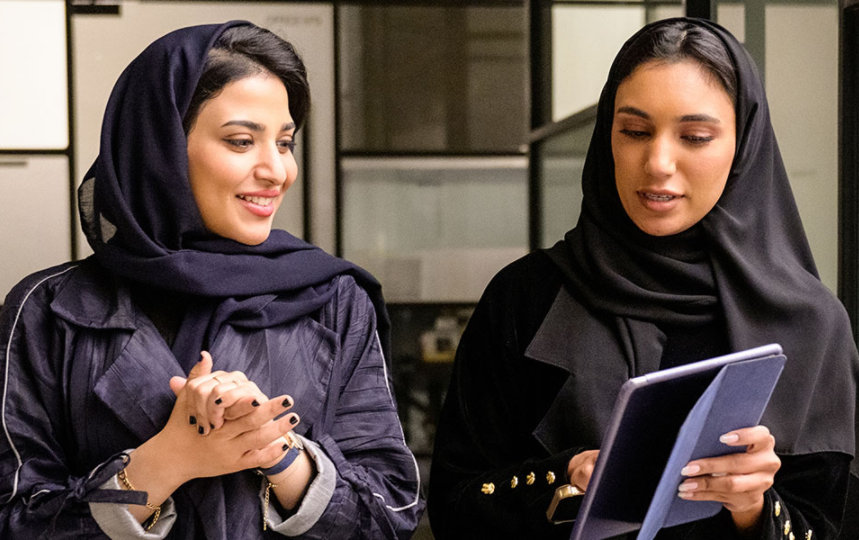 Business associates discussing data on digital tablet