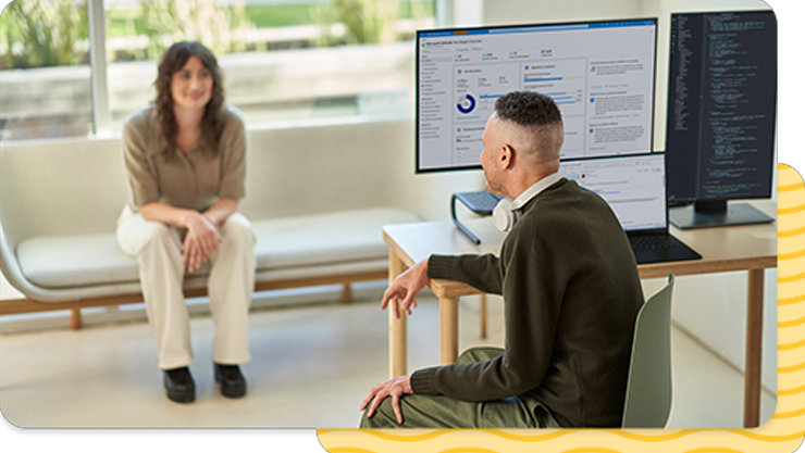 A man and a woman working in the office together.