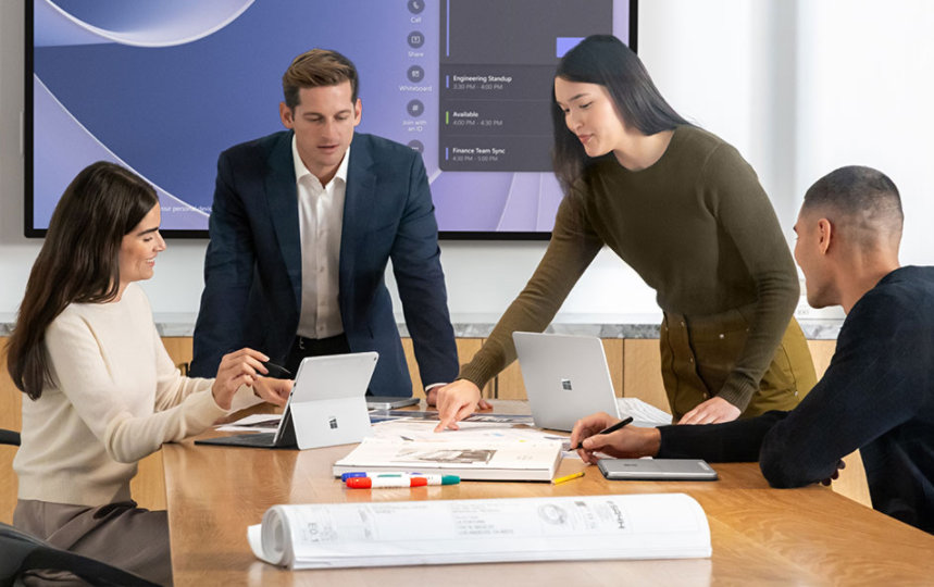 Four executives in a conference room.