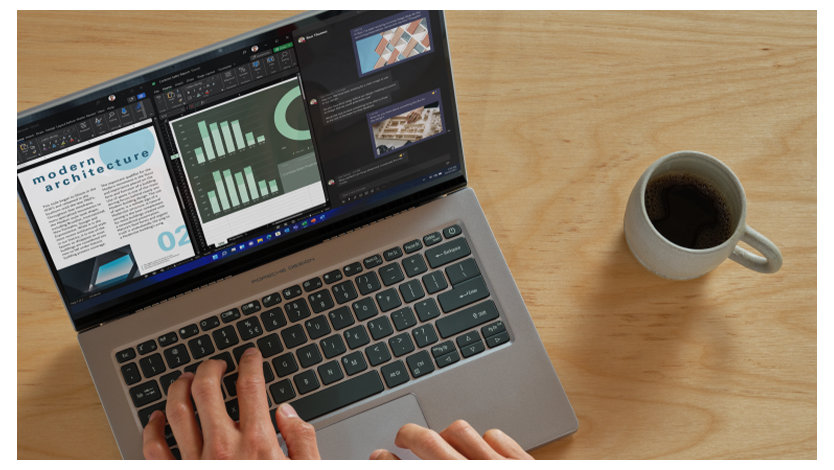 コーヒーカップと一緒にラップトップのキーボードに人間の手