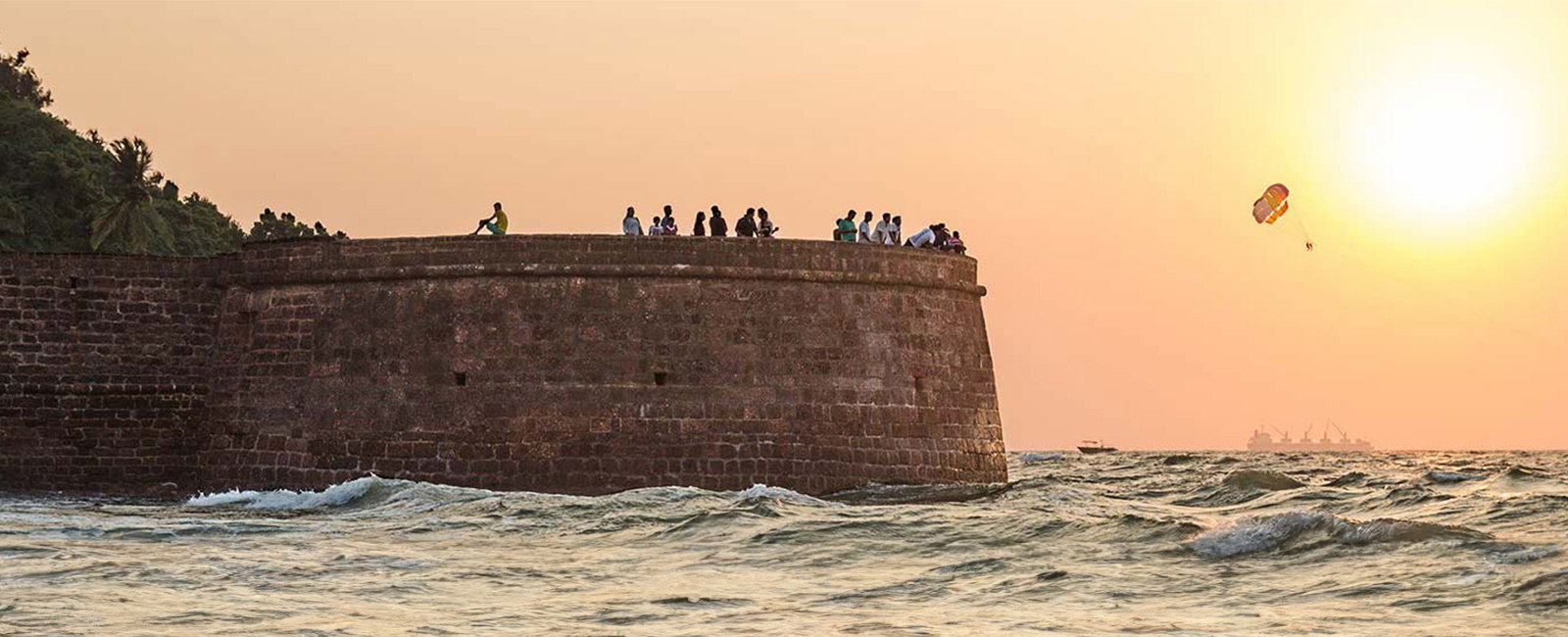 People enjoying sunset from the Aguada Fort in Goa