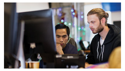 2 人の IT プロフェッショナルがオフィスで一緒に働いています