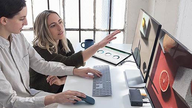パソコンを操作する女性と隣に座りアドバイスする女性