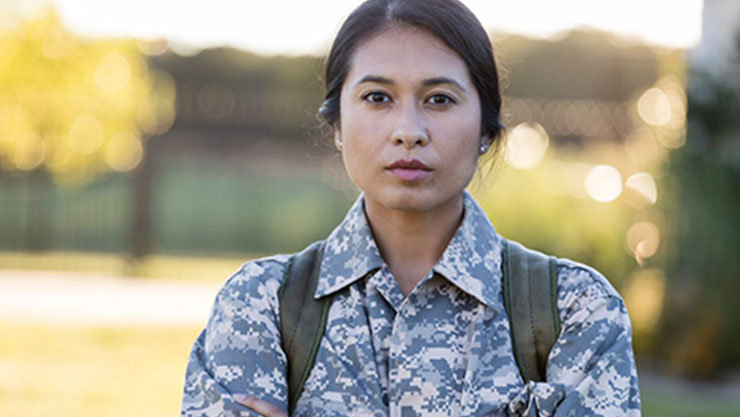 woman staring directly into the camera with her arms crossed