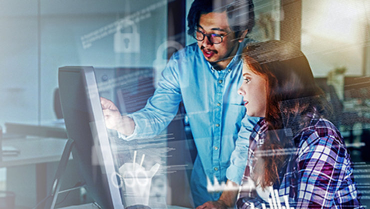 two microsoft trainees in front of a computer