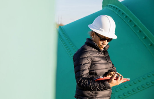 a woman using a tablet in an industrial area