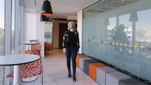 Angela walking through an office