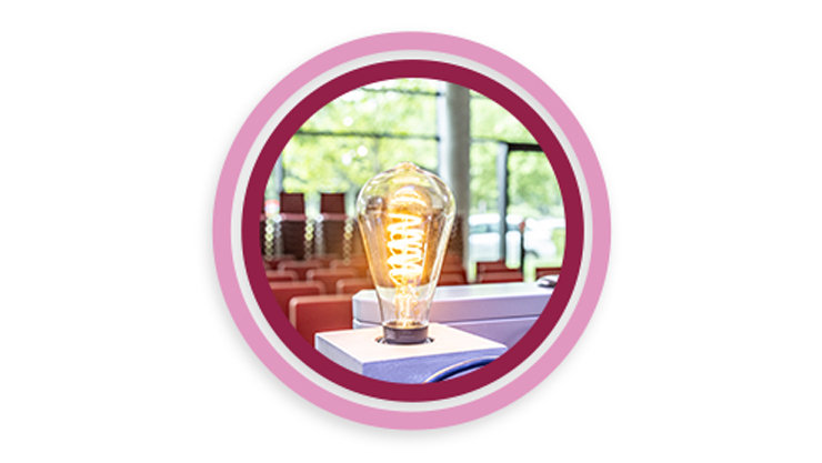 In einem rot-rosa Kreis ist eine leuchtende Glühbirne auf einem Sprecherpult abgebildet