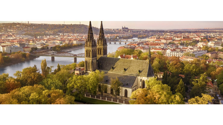 A panoramic view of a city in Czechia with a river flowing through it