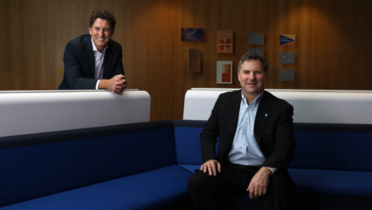 Larry Marshall(CSIRO Chief Executive) shitting on sofa and Steven Worrall (Managing Director, Microsoft ANZ) standing behind with arm resting on beside sofa
