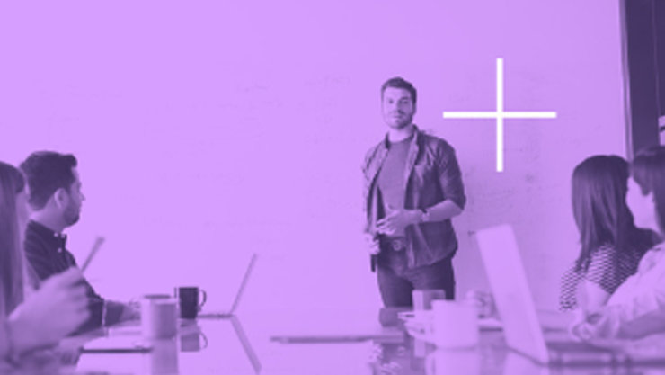 A purple overlay over a background showing people in a discussion in ameeting room