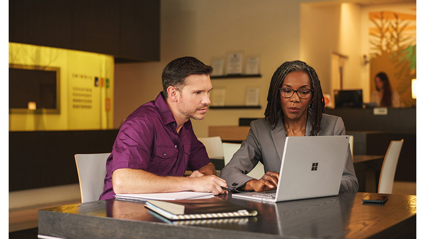 Two microsoft partners sitting in front of a laptop